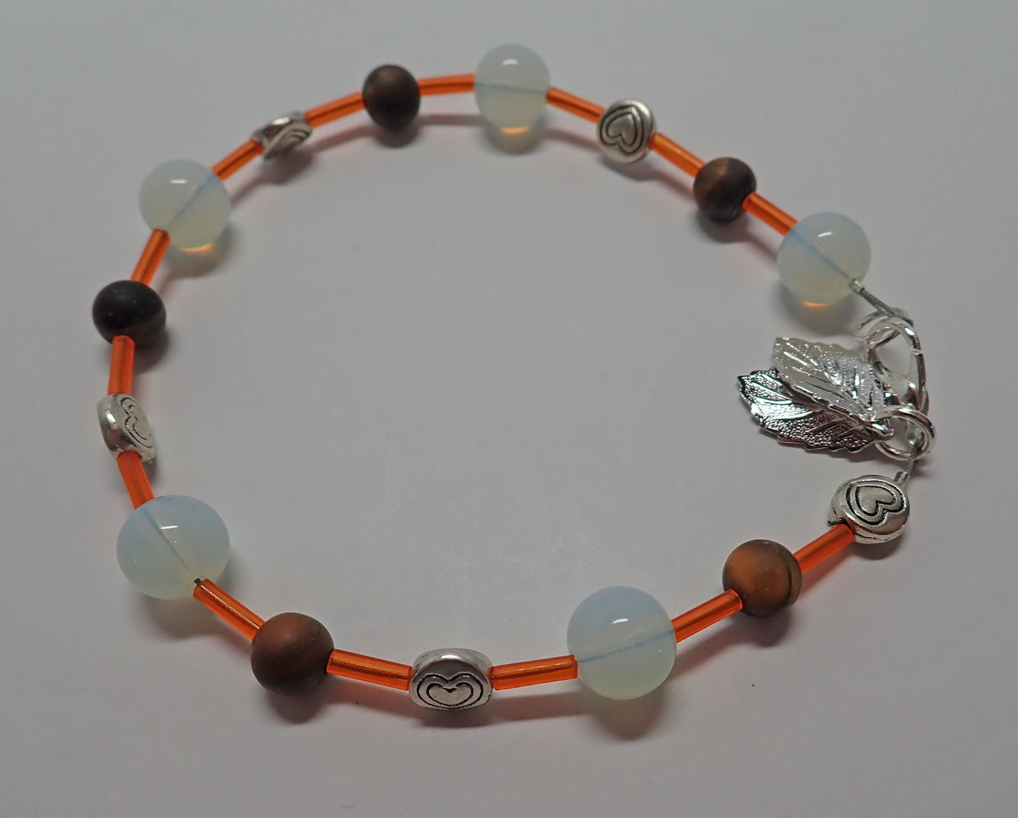 Jewelry, bracelet, glass beads, wooden beads, heart beads, leaf charms, orange, white, brown, gift